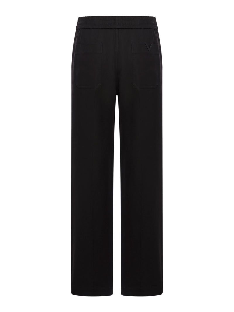 BLACK PANTS WITH METALLIC LOGO